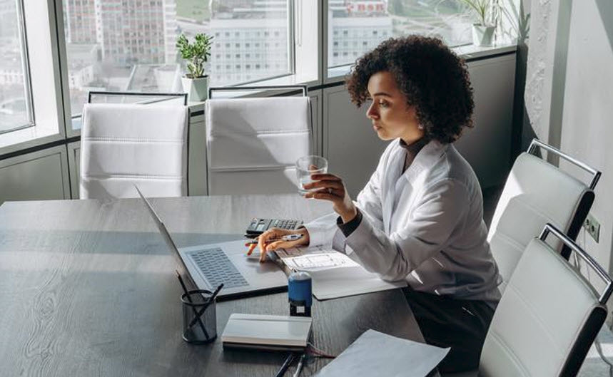 Solo female working on a laptop determining if her candidate is a cultural fit for her client